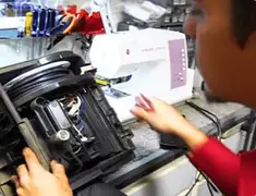 Vacuum repair technician servicing internal components on a workbench in Mobile, AL