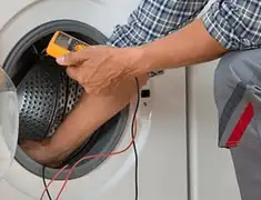 Washing machine repair technician testing a front-load washer with diagnostic tools in Mobile, AL